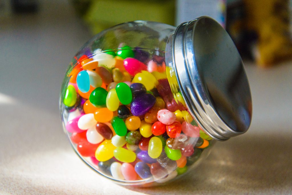 Clear jar with jelly beans in it with a silver lid