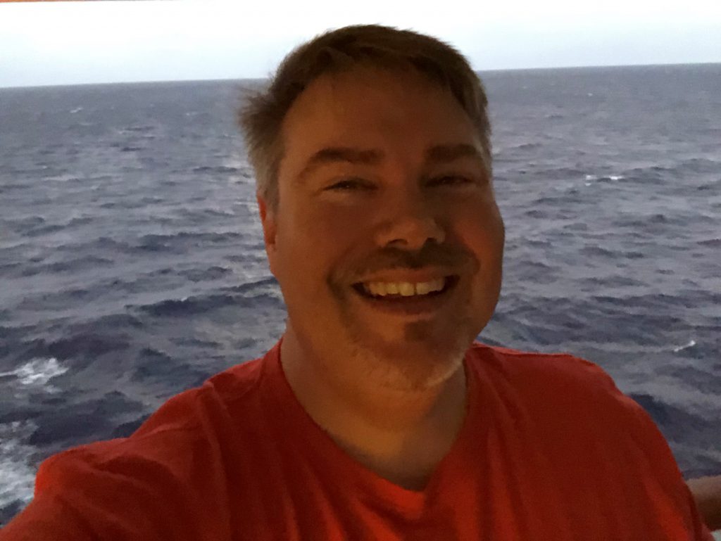 man smiling on a boat