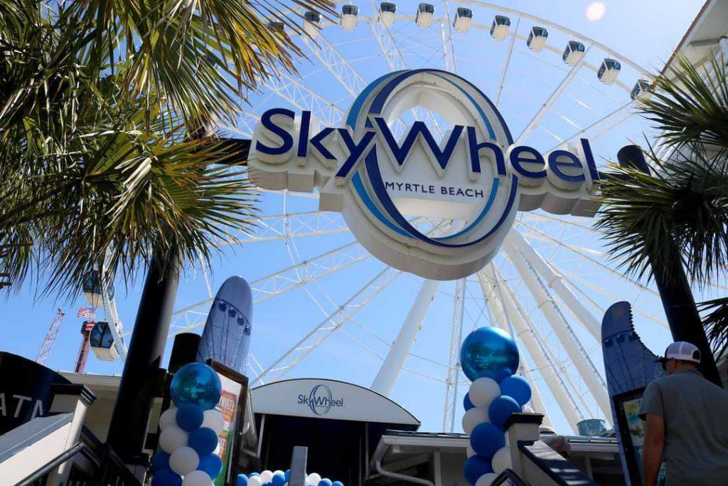 Entrance to Myrtle Beach SkyWheel sign and SkyWheel in background