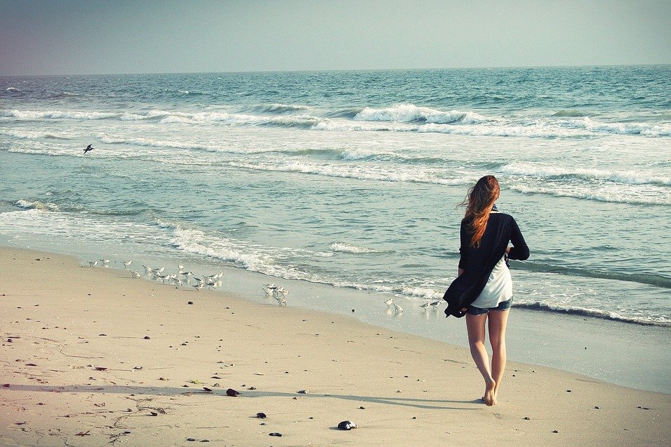 lady walking alone on beach